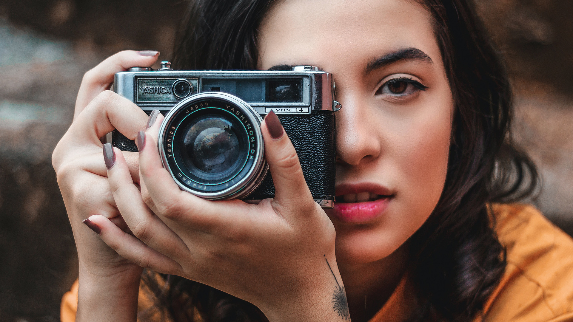 Image of a woman holding a camera.