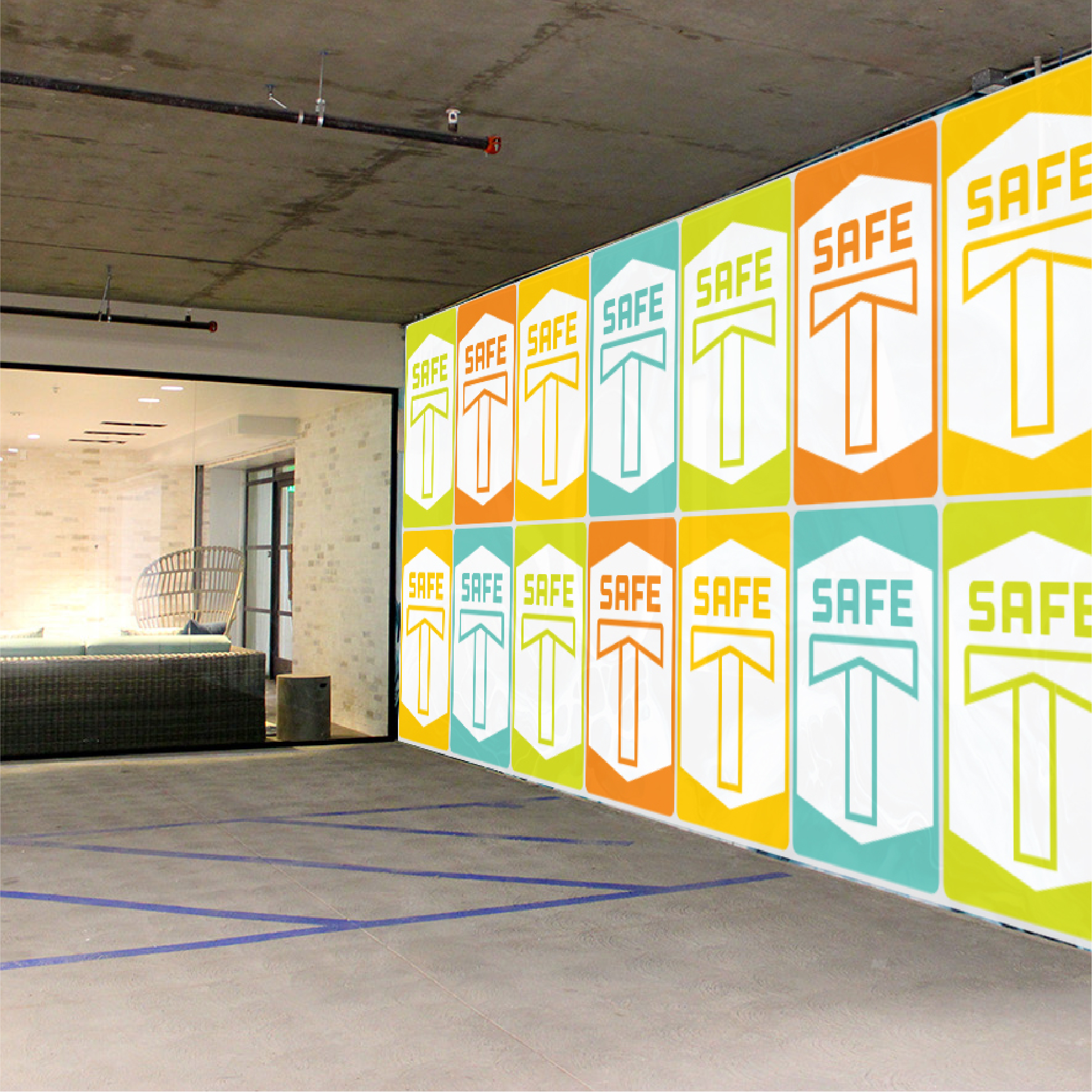 Wall graphic mockup for Safe T campaign. Colorful repeating tiled posters on a wall.