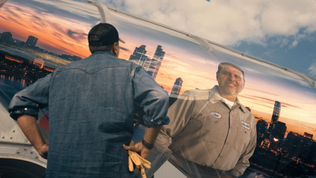 National Tank Truck Carriers See Yourself in a Tank Truck Campaign - A man looking into the side of a tank truck and seeing a promising future in the tank trucking industry
